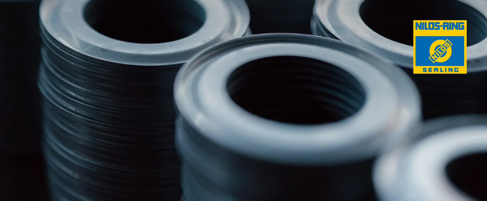 A close-up of stacked Nilos-Rings, the German-made all-metal seals designed for robust protection of industrial ball and roller bearings.