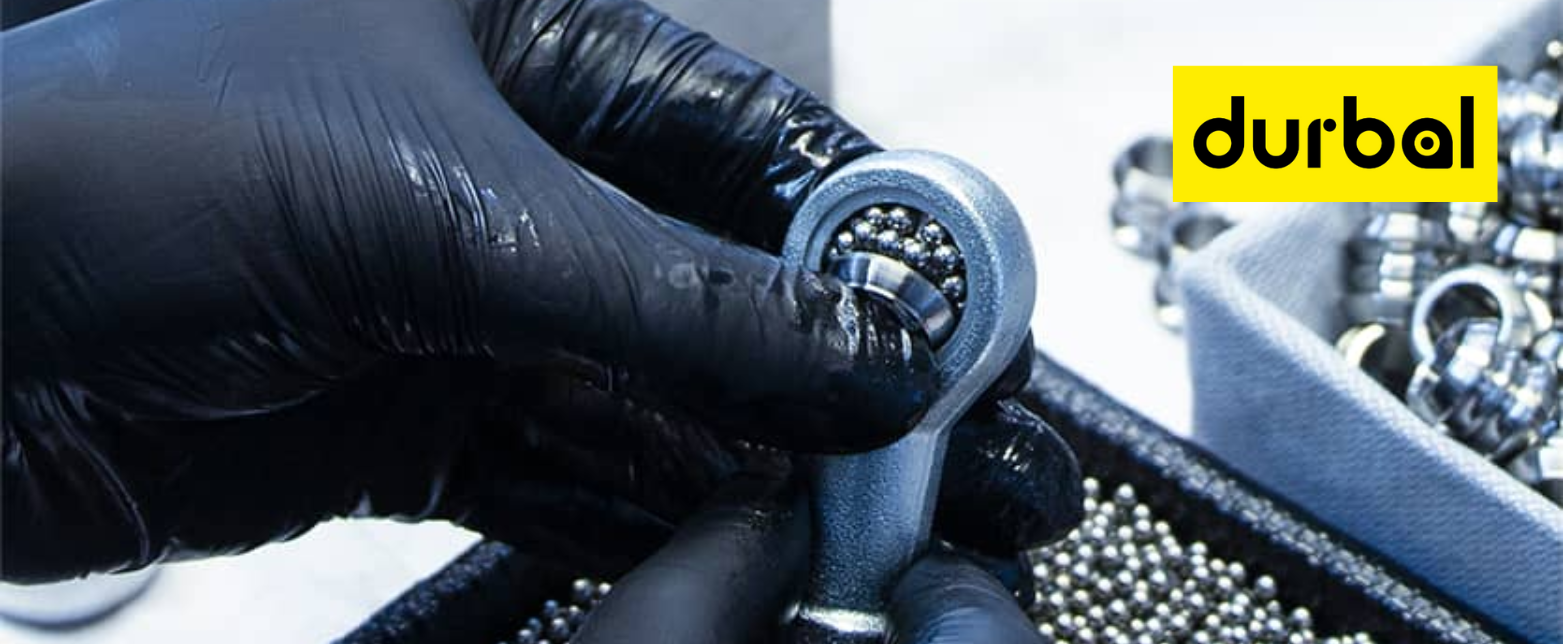 A technician assembles a high-performance Durbal rod end, showcasing the precision of these "Made in Germany" industrial linkage joints.