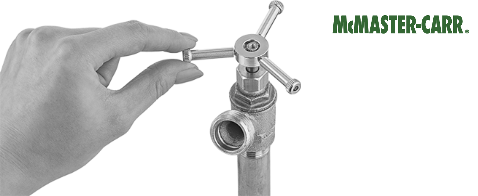 A hand turning a McMaster-Carr 3-prong, star-style valve handle. The durable chrome handle allows for easy control of industrial or plumbing valves.